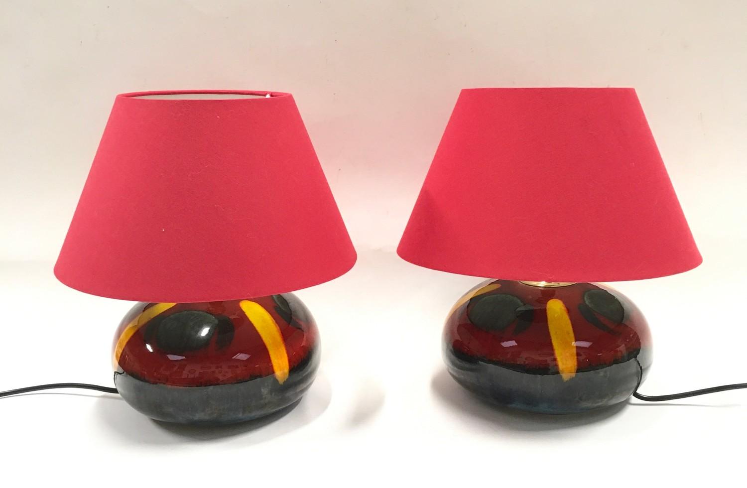 Poole Pottery pair of table lamps with red shades.