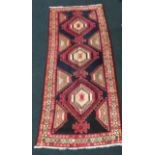 Ardebil carpet in medallion red,cream and blue. 300x122