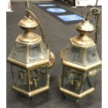 A pair of brass hanging lantern lights.