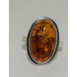 A large Honey Amber 925 Silver ring, size P.