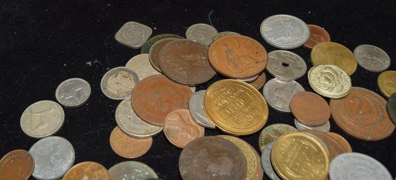 Collection of coins in a plastic tub