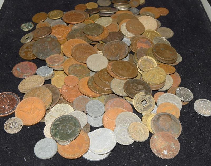 Collection of coins in a plastic tub