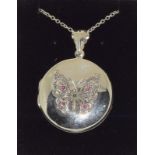 Silver photo locket with embossed decoration of a butterfly