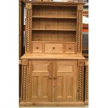 Solid pine two part dresser with turned decoration and carved motifs , fitted inner shelf with three