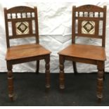 A pair of Edwardian carved parlour chairs with tile backs