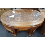 Oak coffee table with carved top depicting African animals together with six matching stools.