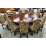 Large mahogany round dining table made up of two sections together with twelve matching chairs