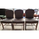 A set of three upholstered chairs.