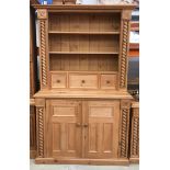 Solid Pine two part dresser with turned supports and carved decoration , top having three spice