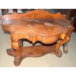 Walnut single draw wash stand with scalloped shape standing on claw feet with a shaped back stand