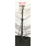 A wrought iron adjustable tripod stand electric uplighter with embossed shade 130cm tall 45cm across