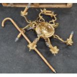 Gold gilt metal eight arm chandelier together with a walking stick.