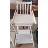 A white painted vintage high chair.