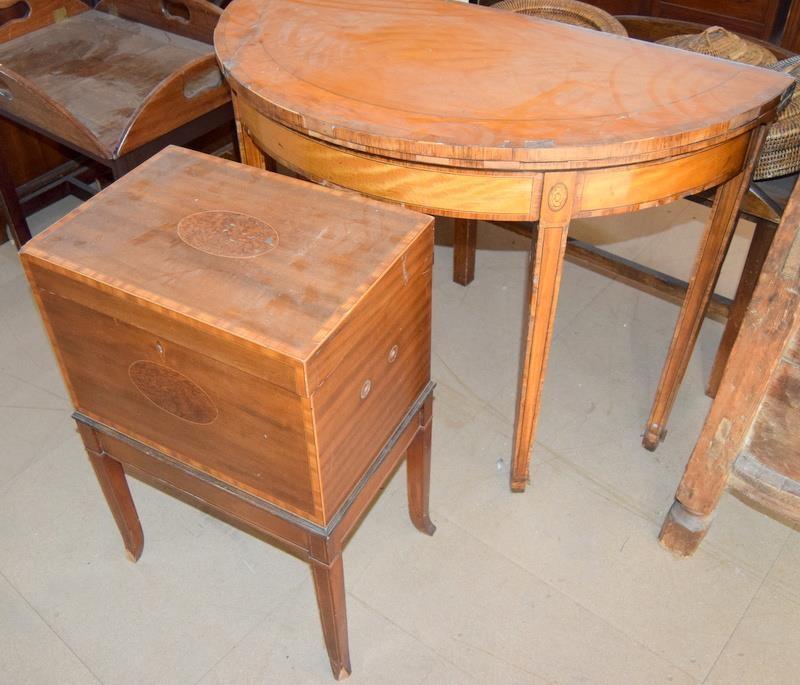 Demi lune games table on tapered supports and an inlaid wine cellar