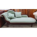 Chaise Longue in a dark hard wood with decorative carving and upholstered in a green and gold