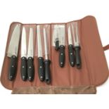 A 9 piece knife set in bag. (ref 63)