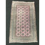Blooch repeated design rug in light red. 180x105