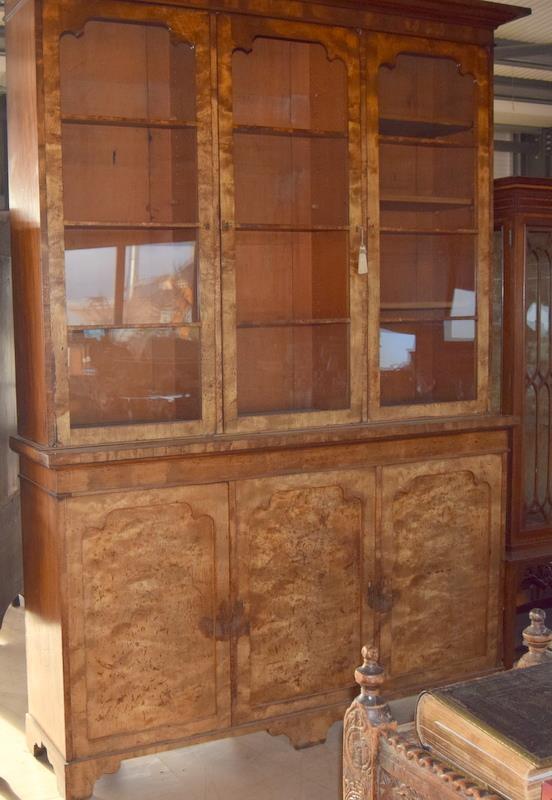 Walnut three door library bookcase with adjustable shelves over a 3 door cupboard base in 2 parts