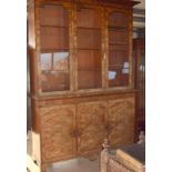 Walnut three door library bookcase with adjustable shelves over a 3 door cupboard base in 2 parts