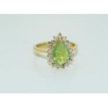A pear shaped natural green opal and diamond 18ct gold ring. Size N. 4.9 grams.