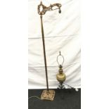 Brass oil lamp an wrought iron base converted to electric together a brass standard lamp with