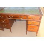 Edwardian mahogany writing desk with leather top and fitted draws to the sides on tapered legs