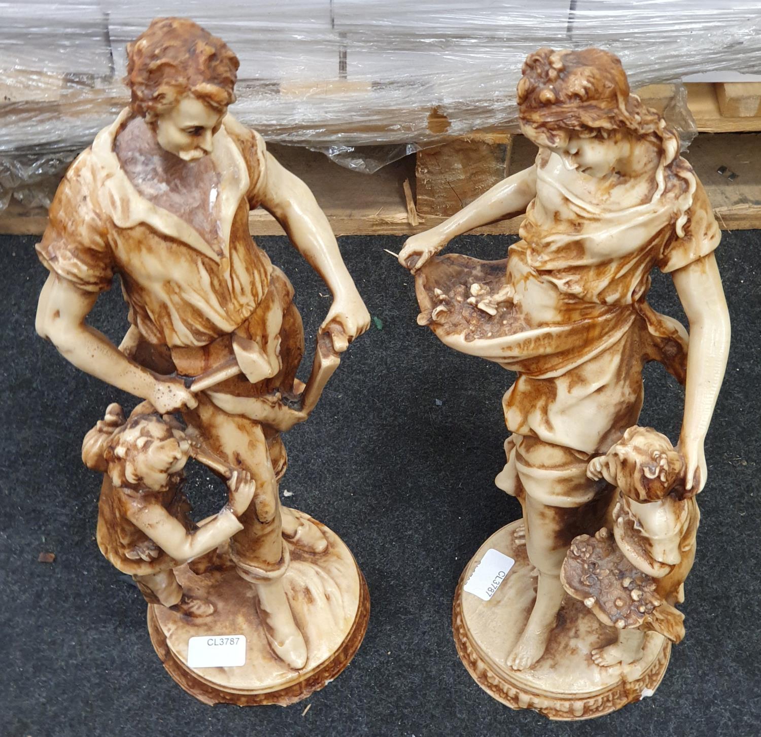 A pair of resin figurines.