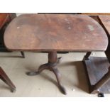 A tilt top occasional table on tripod base.