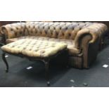 Distressed leather Chesterfield sofa and matching footstool,the stool having cabriolet legs