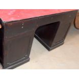 Dark stained clerks pedestal desk with covered top surface and adjustable shelf cupboards