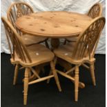 Pine round tripod kitchen table, together with four pine wheel back kitchen chairs 75 x 90 cm