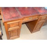 Mahogany leather top clerks desk with fitted draws behind a cupboard door and adjustable shelf to