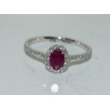 18ct white gold Ruby and Diamond cluster ring of approx 70 pionts size N