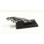 Jaguar car mascot mounted on onyx base.