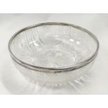 Cut glass bowl with silver rim.