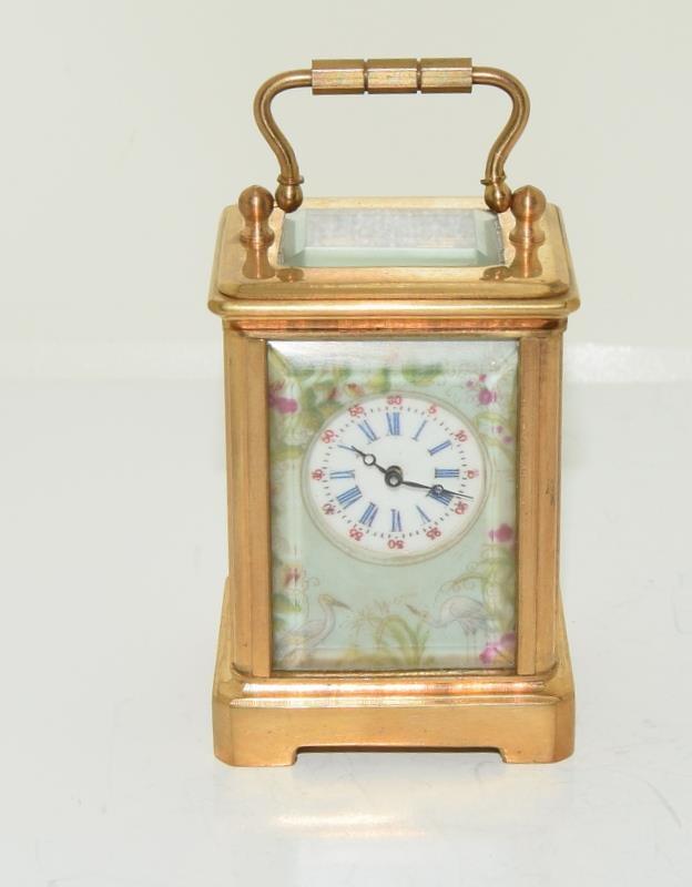 Brass cased miniature carriage clock with porcelain panels