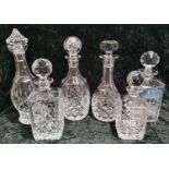 A collection of six crystal glass drinks decanters of various sizes.