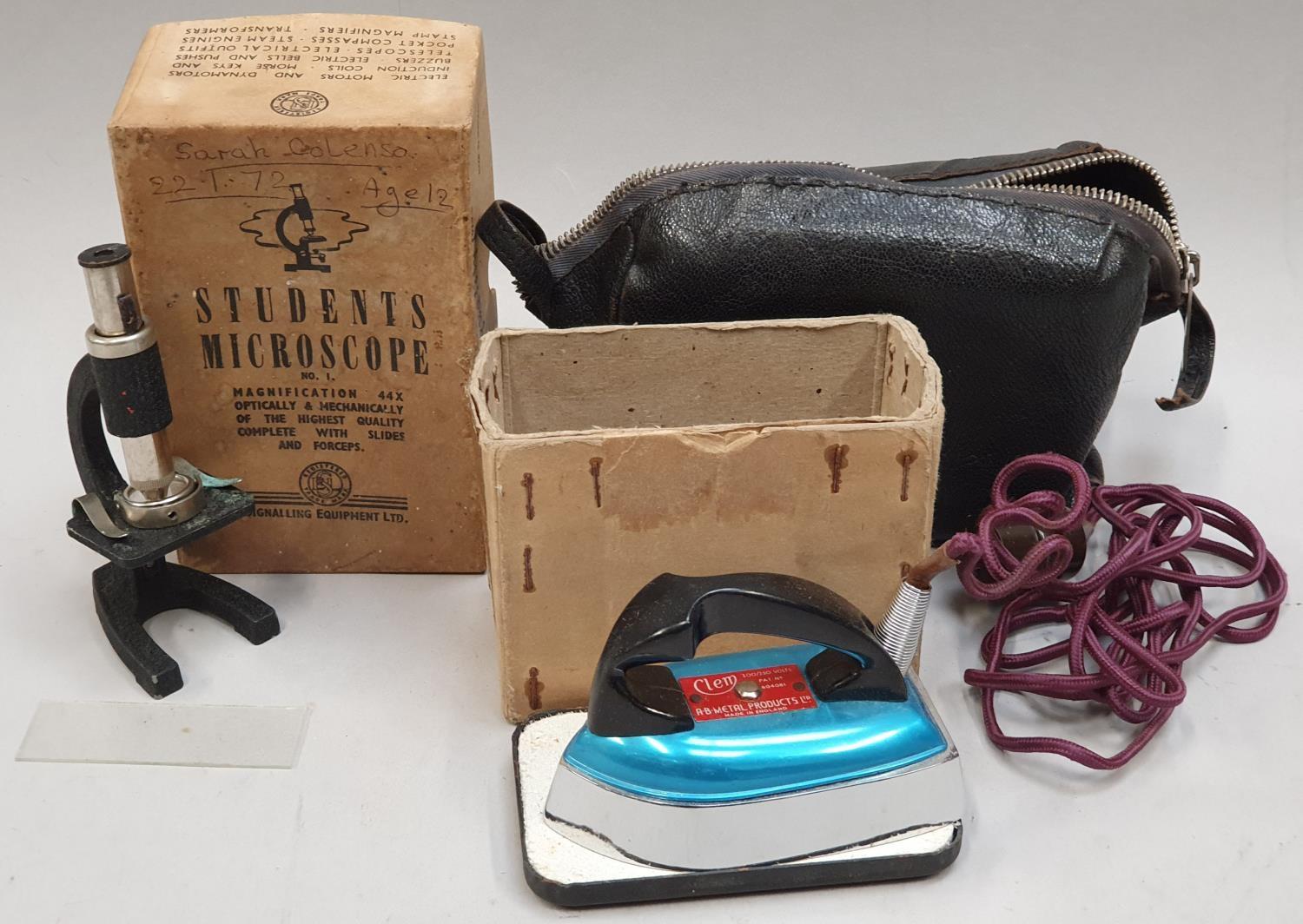 A vintage boxed Students Microscope together with a vintage boxed miniature travel Iron in leather