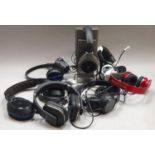 A collection of eight pairs of wireless/wired headphones/headsets by various manufacturers to