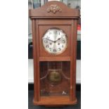 Oak cased wall hanging striking clock with key and pendulum