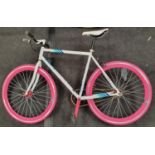 White bicycle with pink tyres.