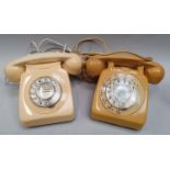 A pair of vintage dial telephones.