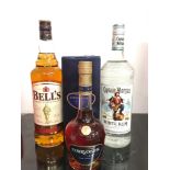 Three bottles of alcohol: Bell?s Scotch Whisky 1L, Captain Morgan White Run 1L, Courvoisier VSOP