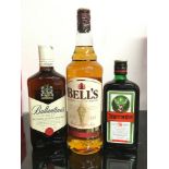 Three bottles of alcohol: Bell?s Scotch Whisky 1L, Ballantine Scotch Whisky 70cl, Jägermeister .