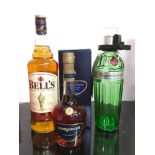 Three bottles of alcohol: Bell?s Scotch Whisky 1L, Tanqueray No.Ten Gin 70cl, Courvoisier VSOP