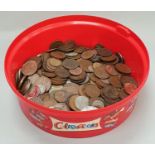 Red tub of assorted coinage