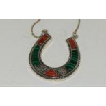 A silver horseshoe pendant necklace with Malachite and Agate.