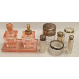 Collection of silver topped perfume bottles etc.