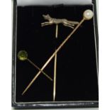 3 gold stick pins one depicting a fox, one set with a pearl the other with Peridot stone