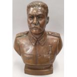 A cast bronzed metal bust of Stalin 30cm tall.